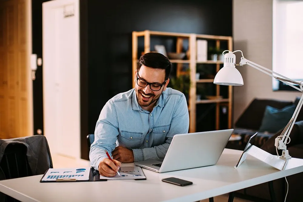 Man sitting at desk in home office space