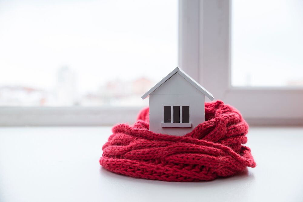 A scarf wrapped around a model house for cost and energy saving