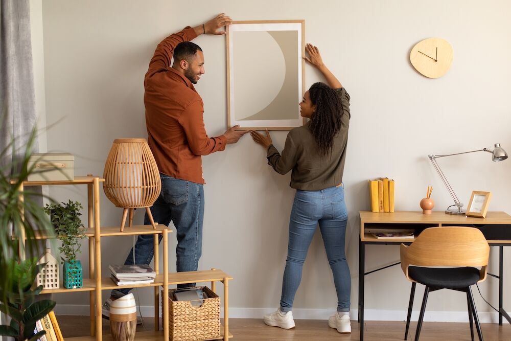 A young couple decorating their new place at the best apartments in Kansas City