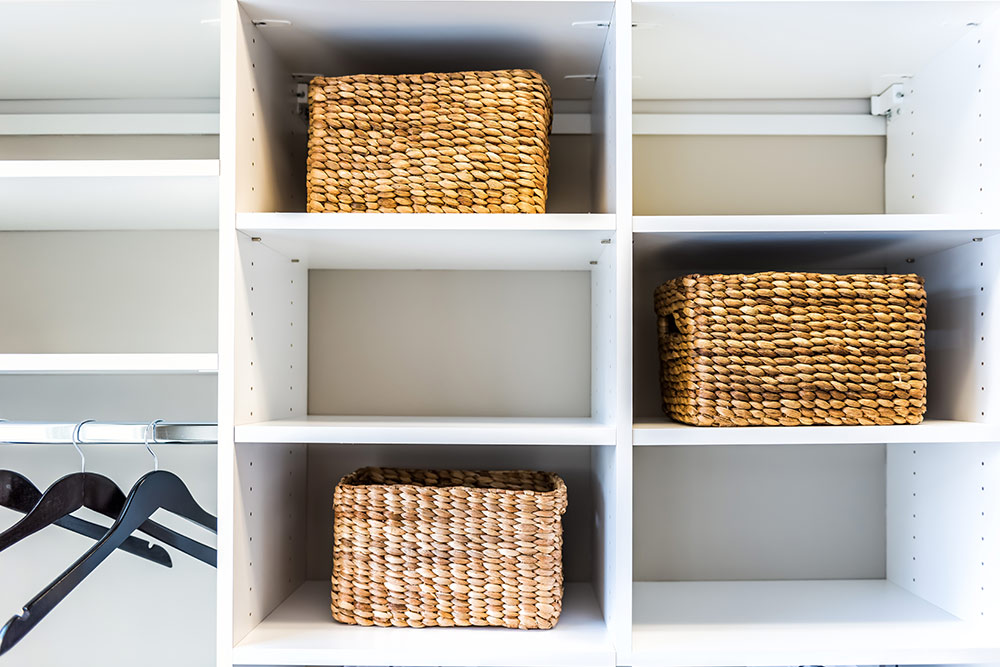 Basket organizers in closet, clean and tidy space