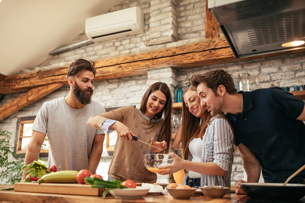 A group of friends cooking together in an apartment