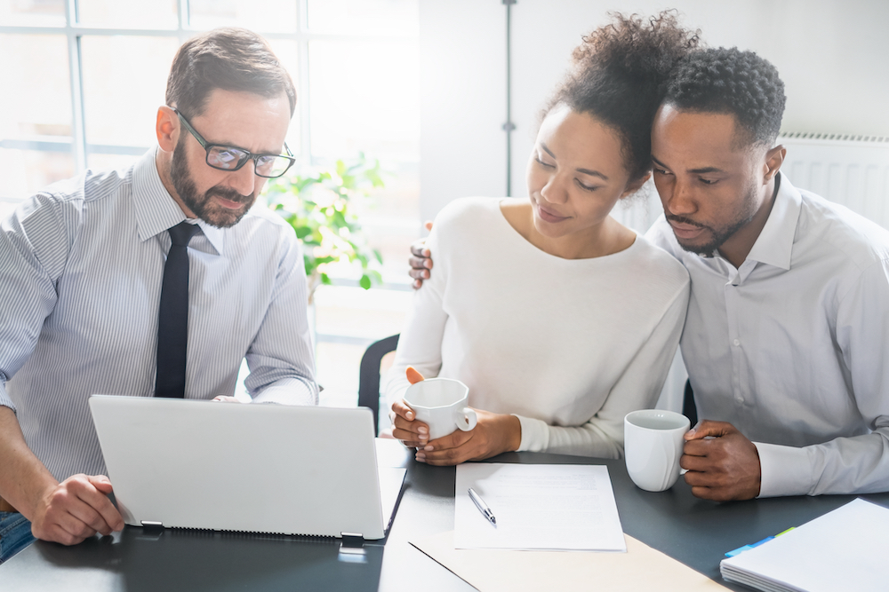 A young couple talks with an insurance agent