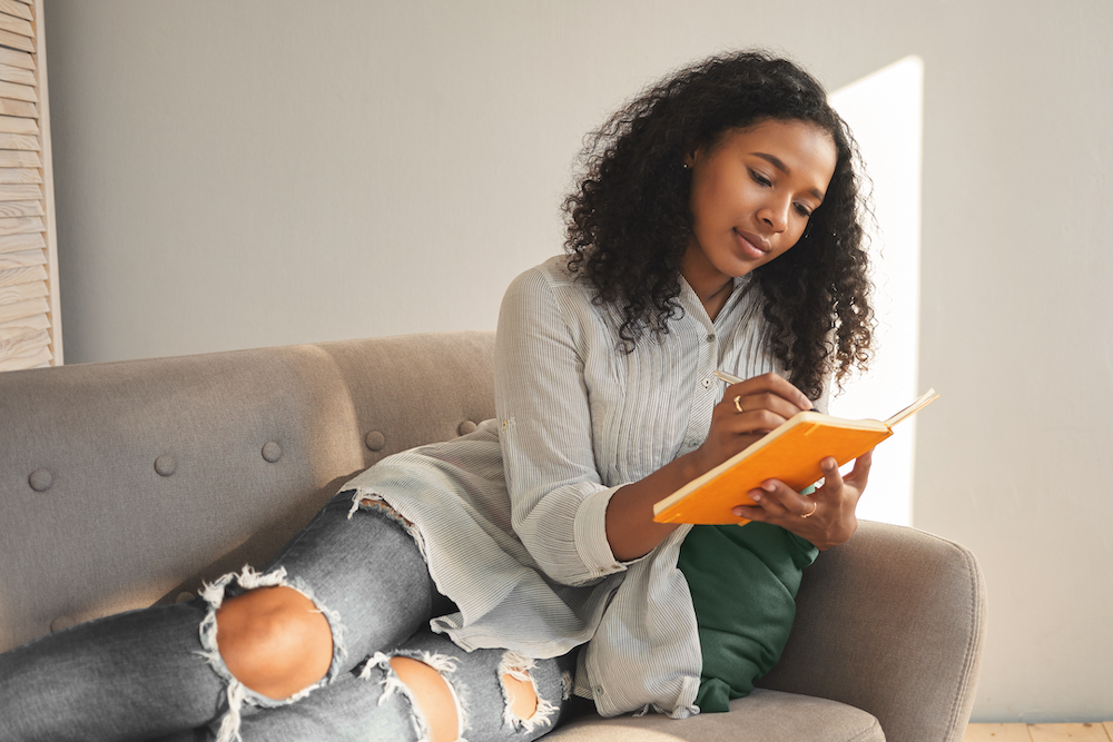 A young woman making a list for when she browses through apartments for rent in Kansas City