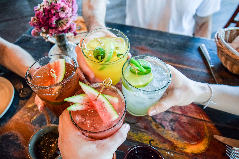 Friends toasting with custom summer cocktails