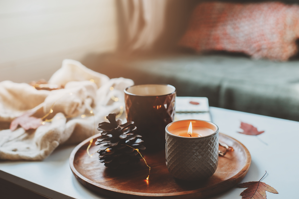 A cozy arrangement of fall candles on a coffee table.