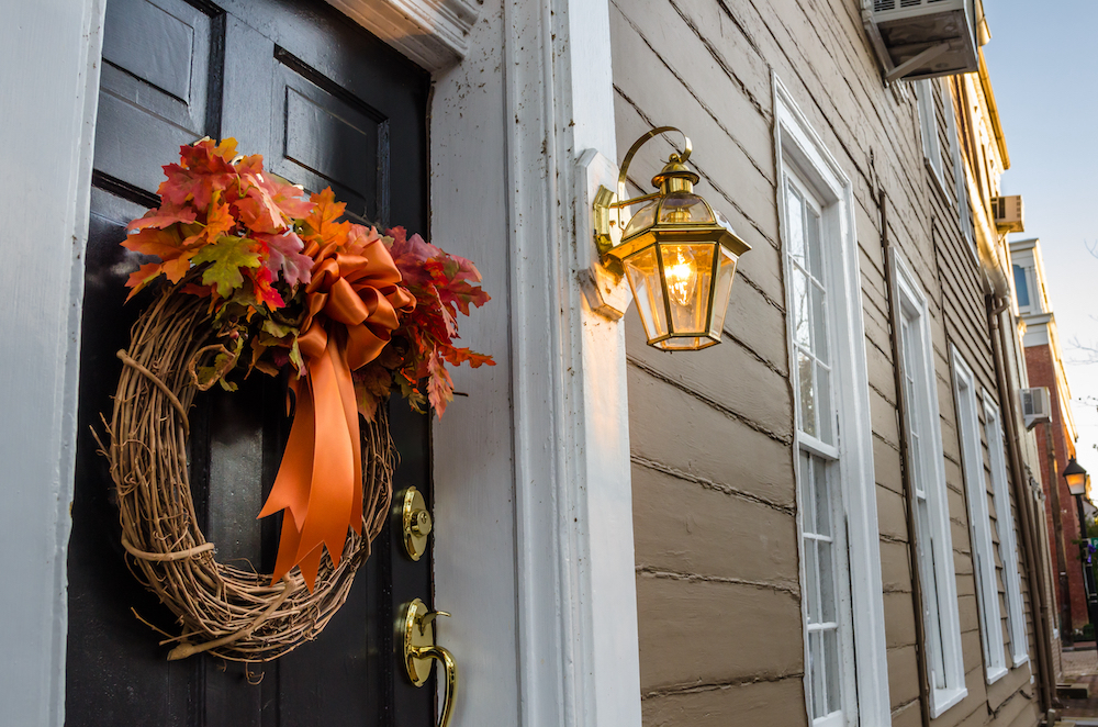 A fall wreath hanging outside on an apartment front door