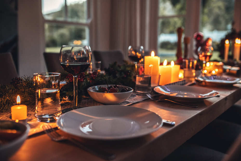 A dining room table set up with seasonal decor for a dinner party
