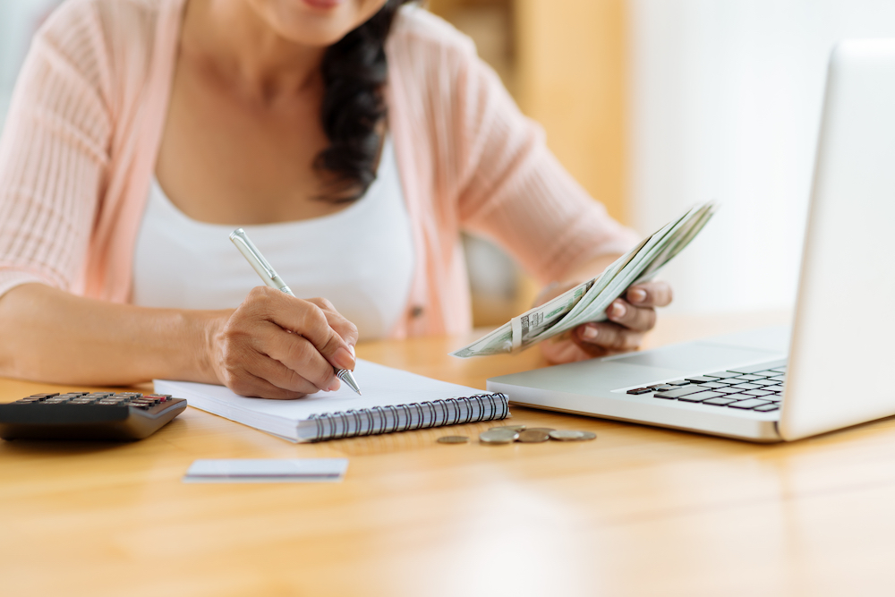 A woman creating a budget for her new apartment