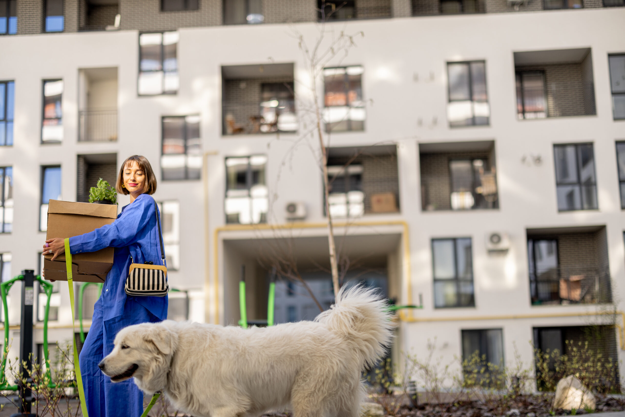 Woman walks dog in best apartments in Kansas City.