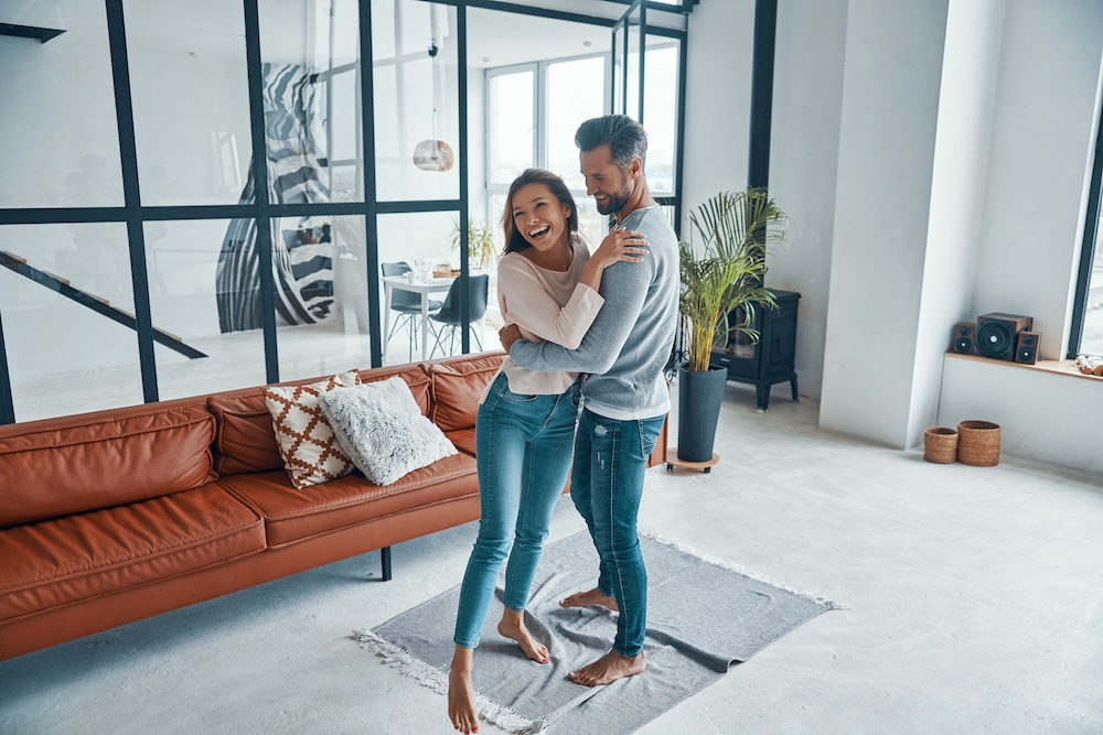 Young couple embracing in their woodside village apartments