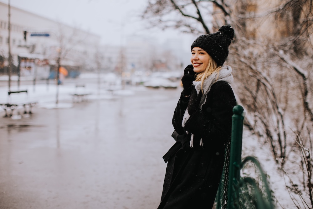 Young woman outside in winter going back to her luxury apartments in KC